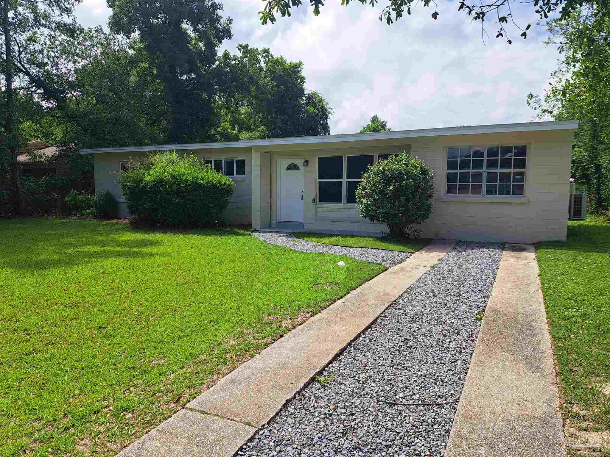 front view of a house with a yard