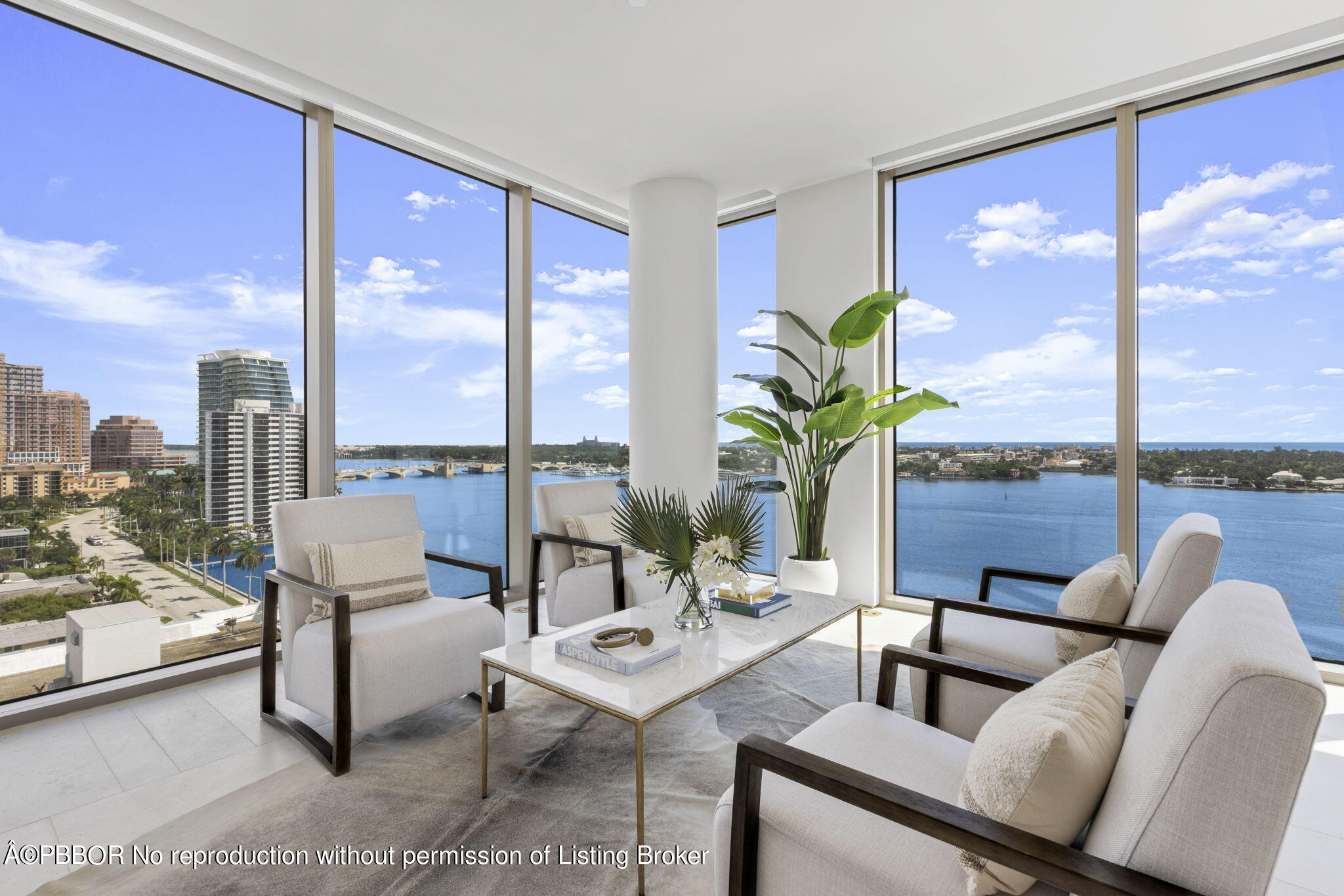 a living room with furniture and floor to ceiling windows