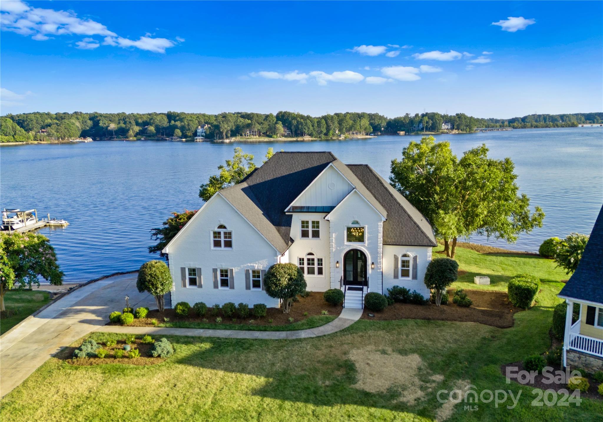 a view of a house with outdoor space and a lake view