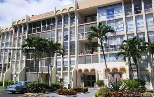 a front view of a building with plants