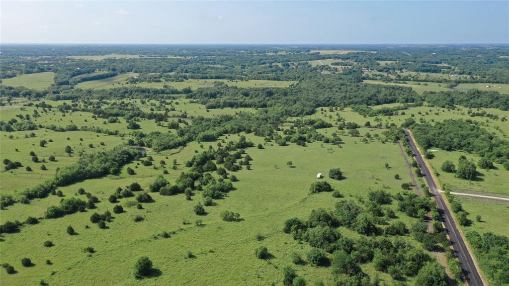 an aerial view of a houses with a yard