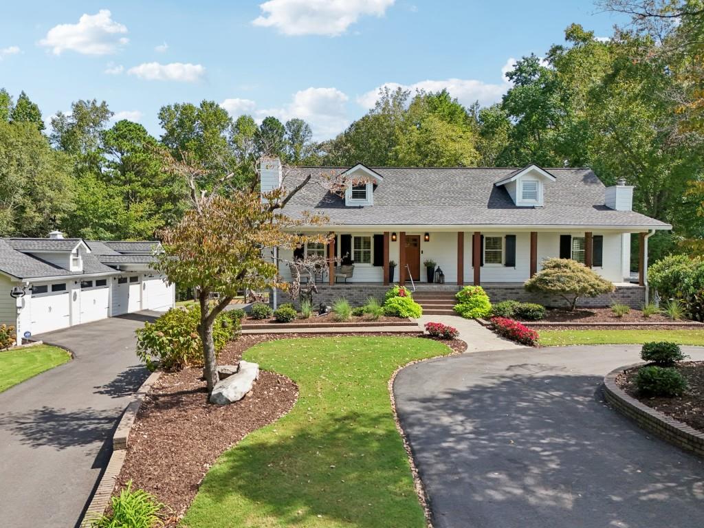 a front view of a house with swimming pool having outdoor seating