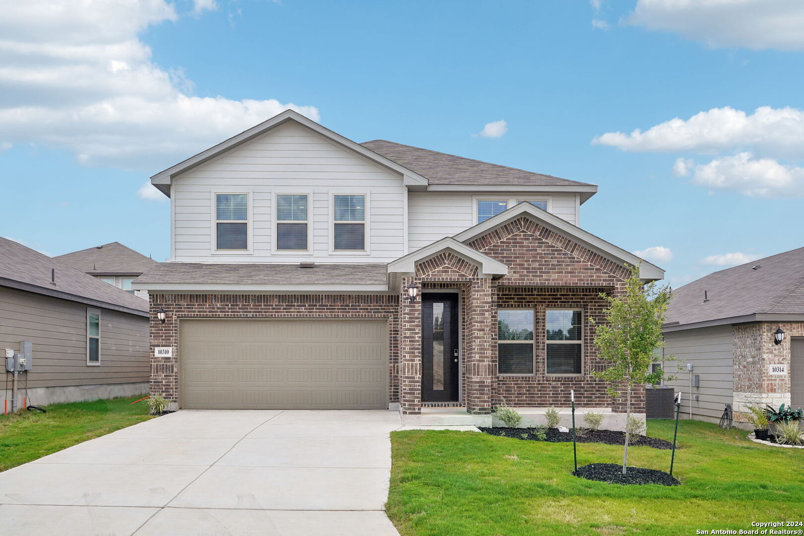 a front view of a house with a yard fire pit and outdoor seating