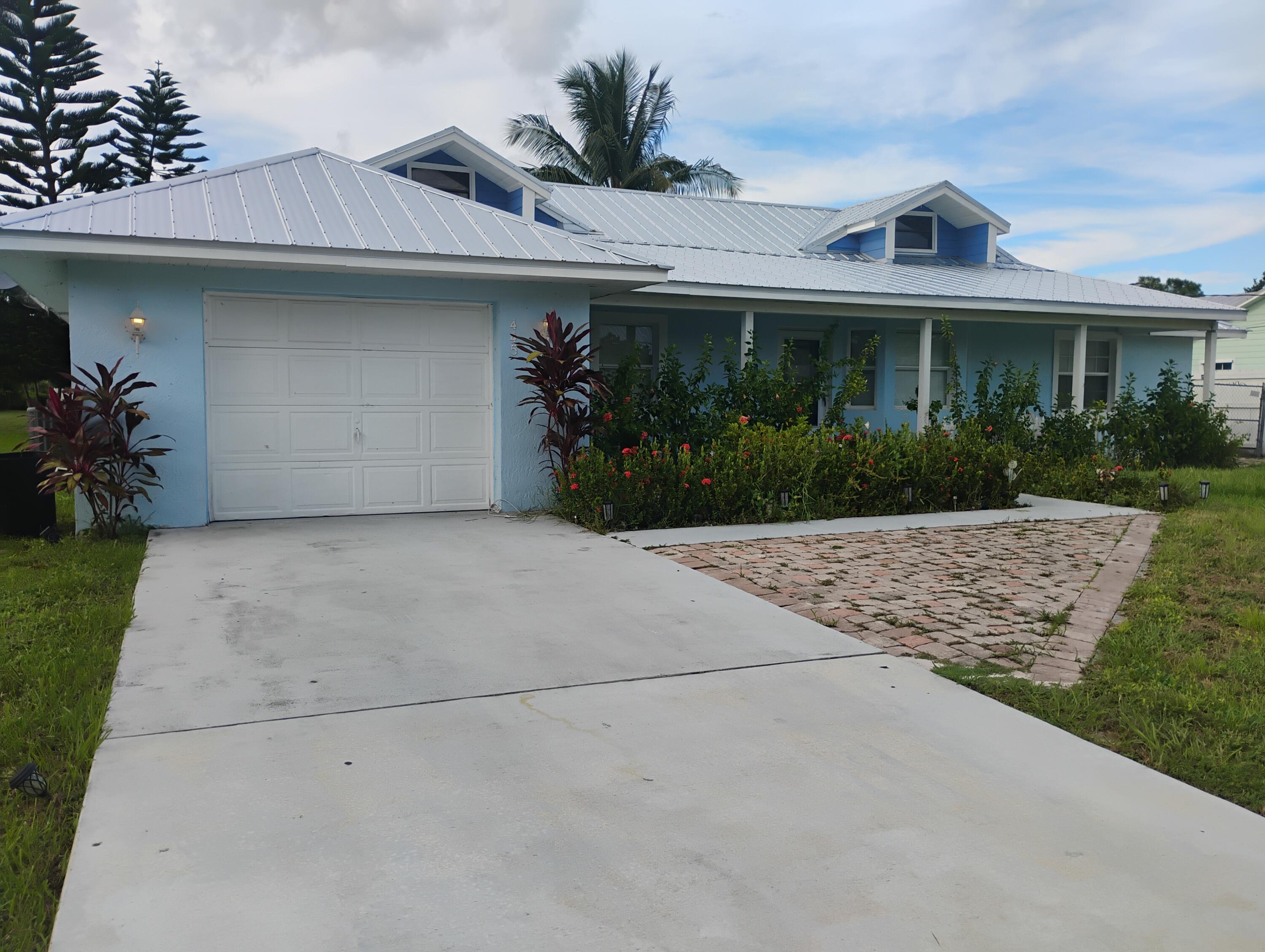 a front view of house with a garden