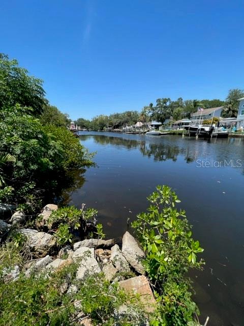 a view of a lake with houses in the back