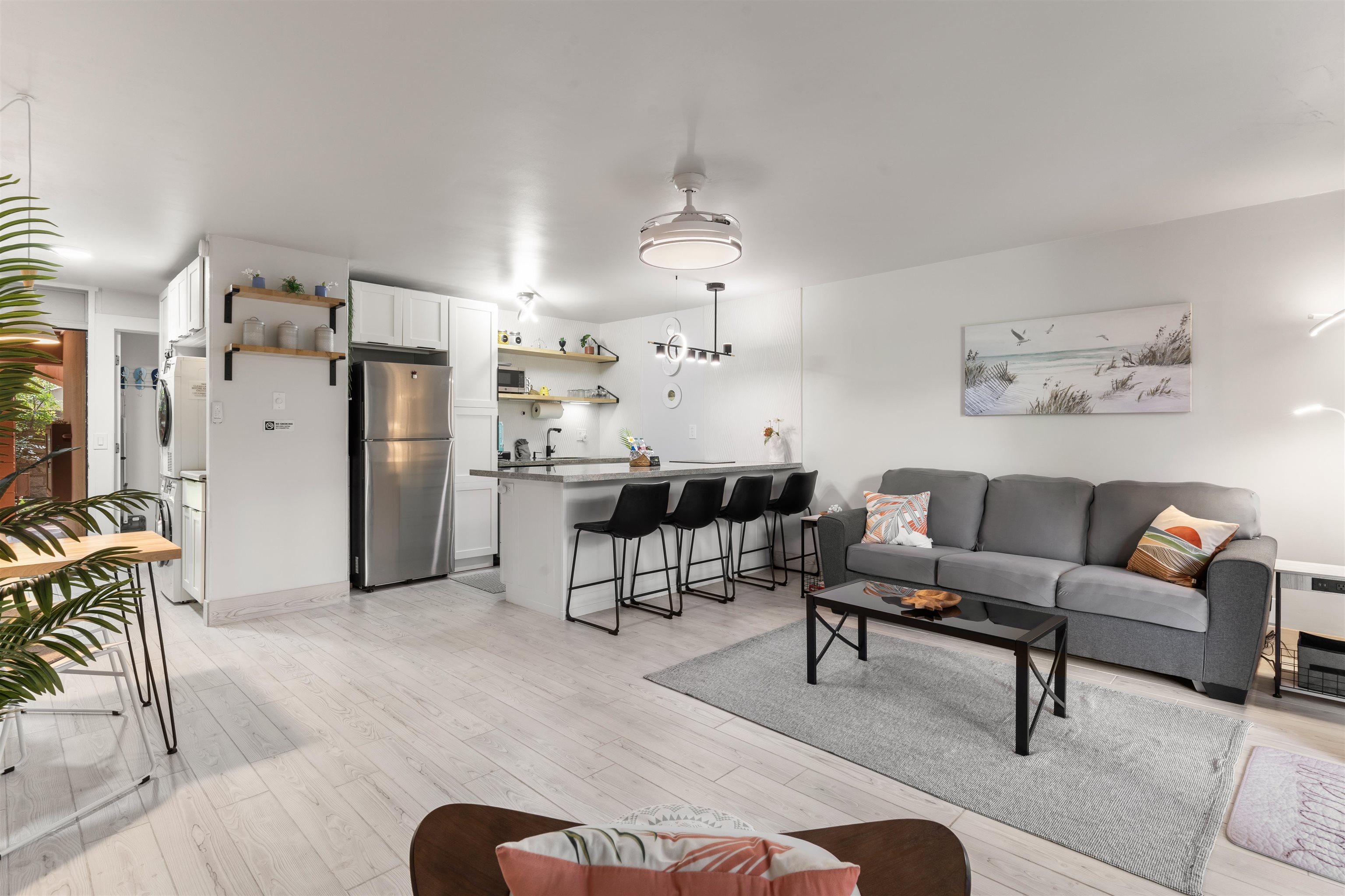 a living room with furniture and kitchen view