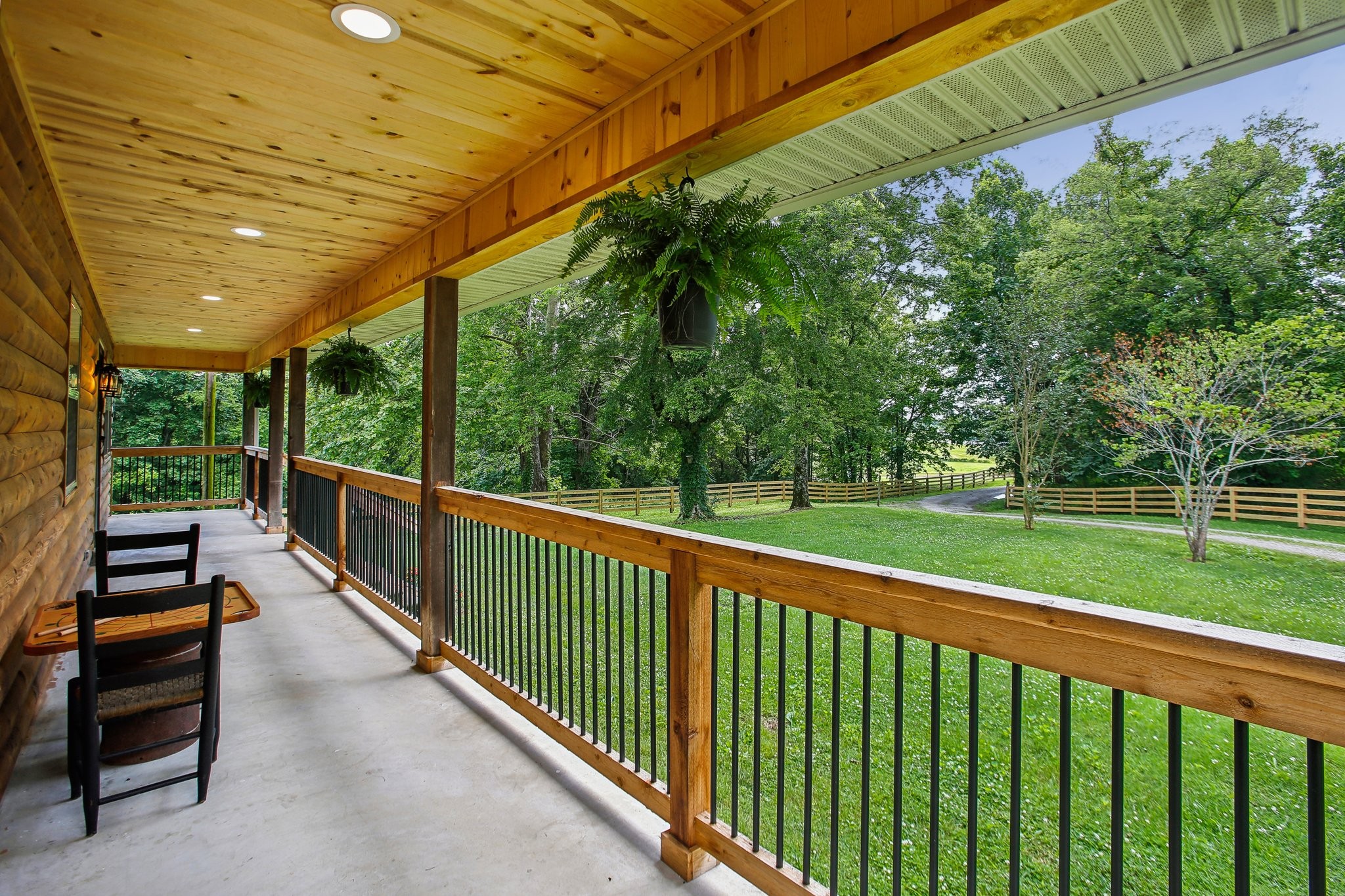 a view of street with a floor to ceiling window and wooden fence