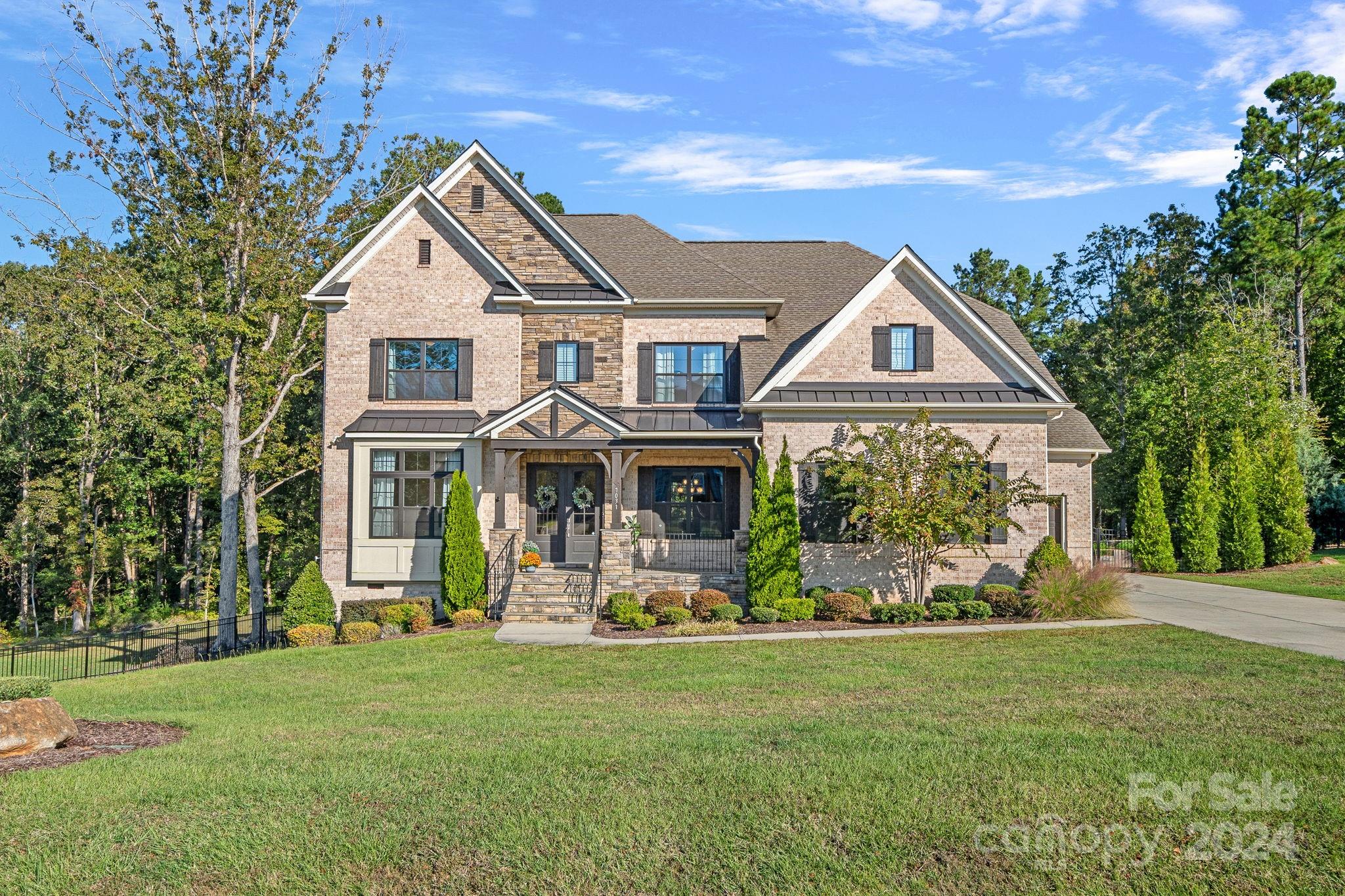 a front view of a house with garden