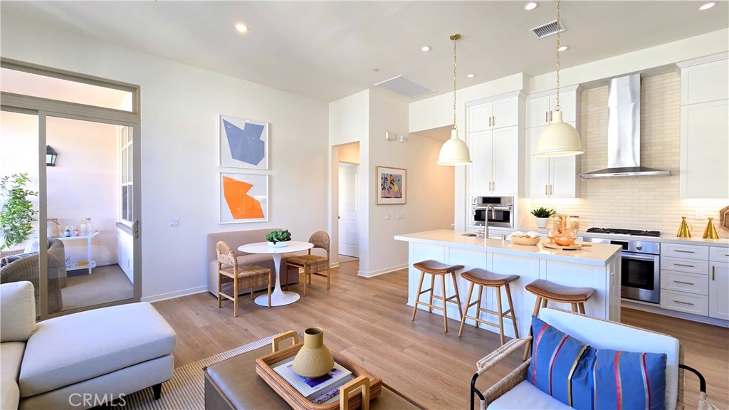 a living room with furniture a dining table and a large window