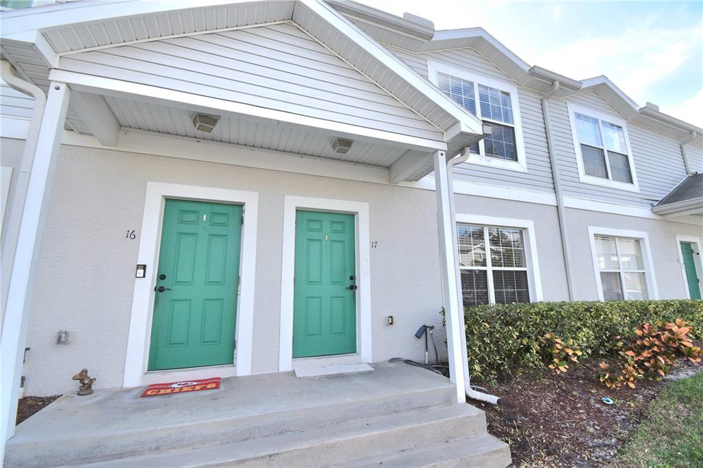 a view of a front door and a yard