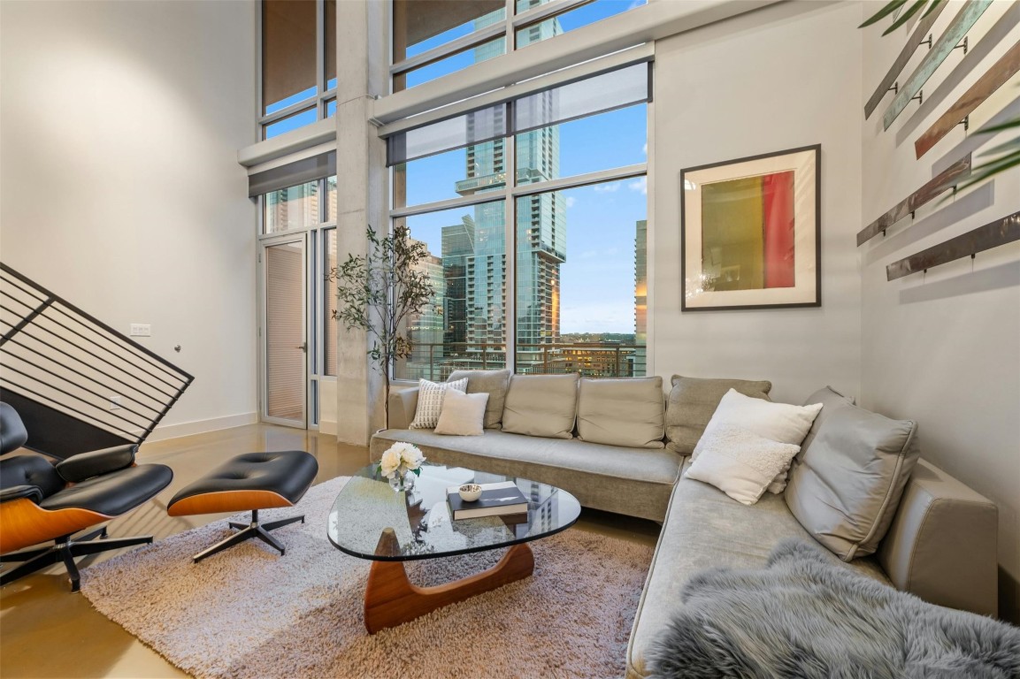 a living room with furniture a rug and a window