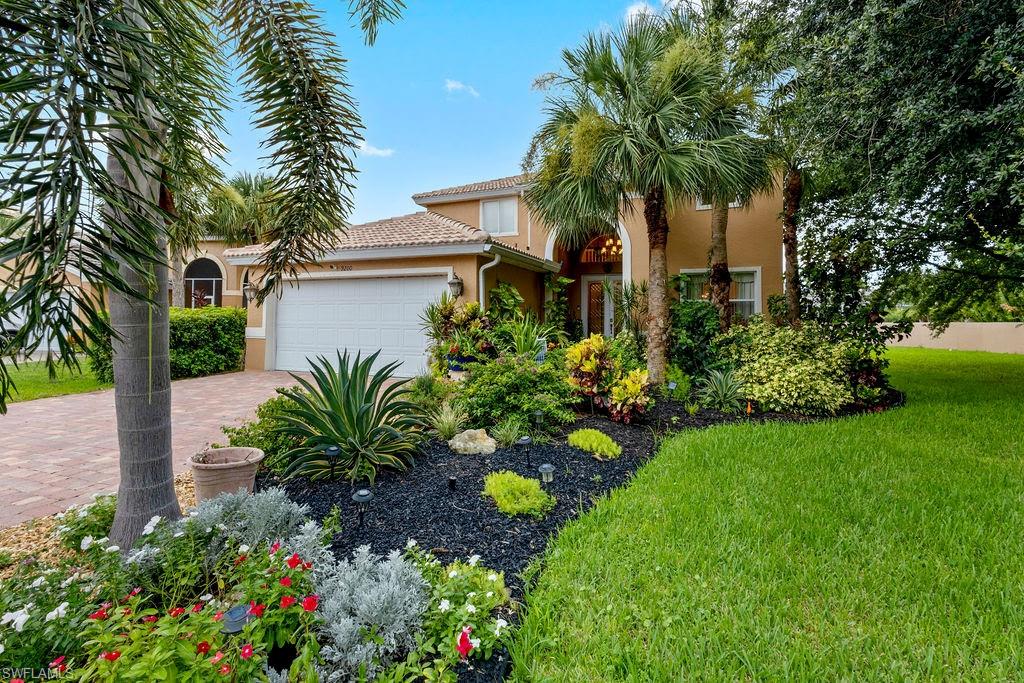 Mediterranean / spanish-style house featuring a garage and a front yard