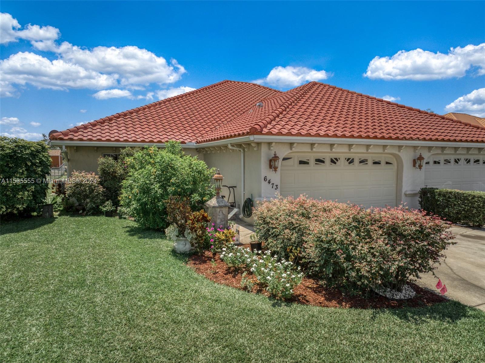 a front view of a house with garden