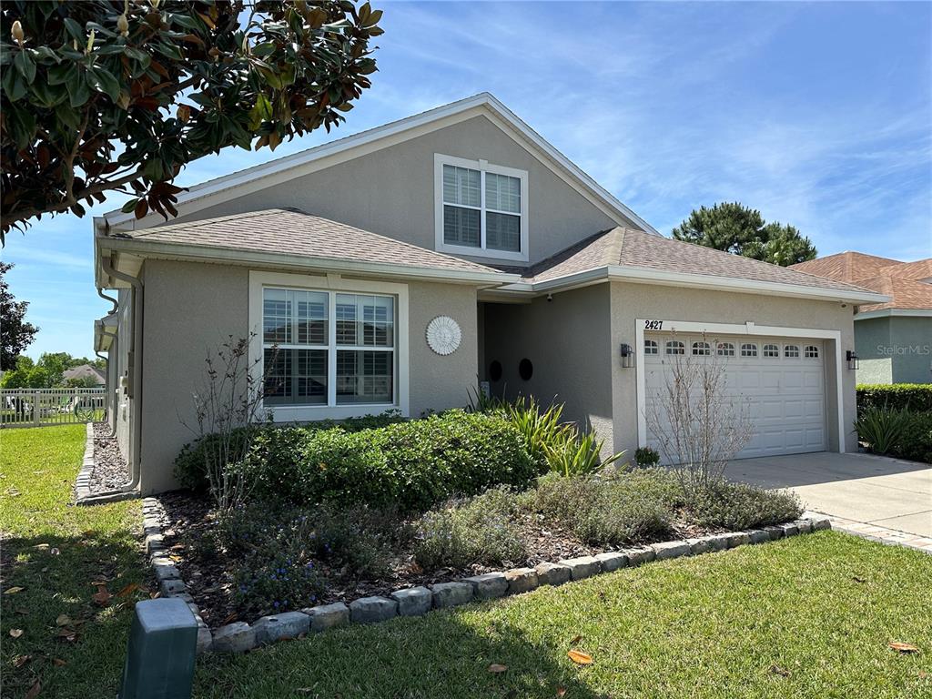 a front view of a house with a yard and garage