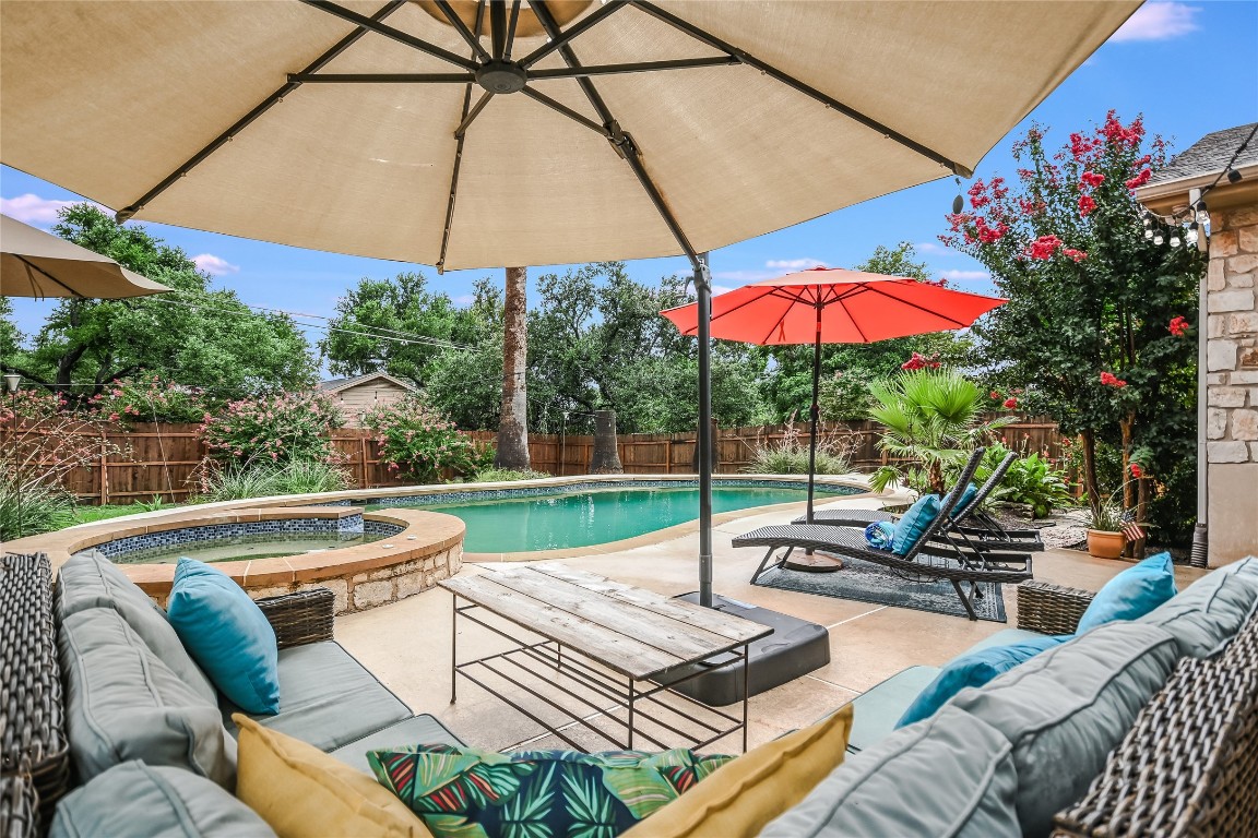 a view of a patio with a table and chairs under an umbrella