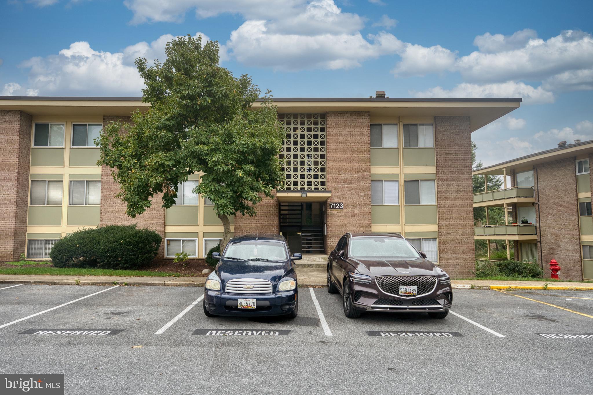 a car parked in front of a brick house