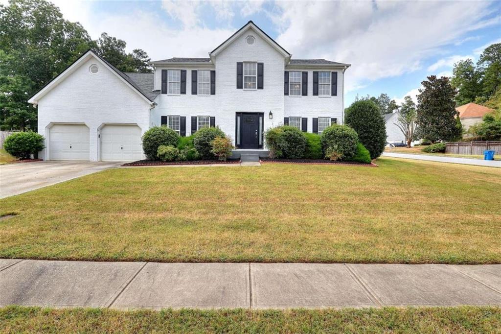 a front view of a house with a yard