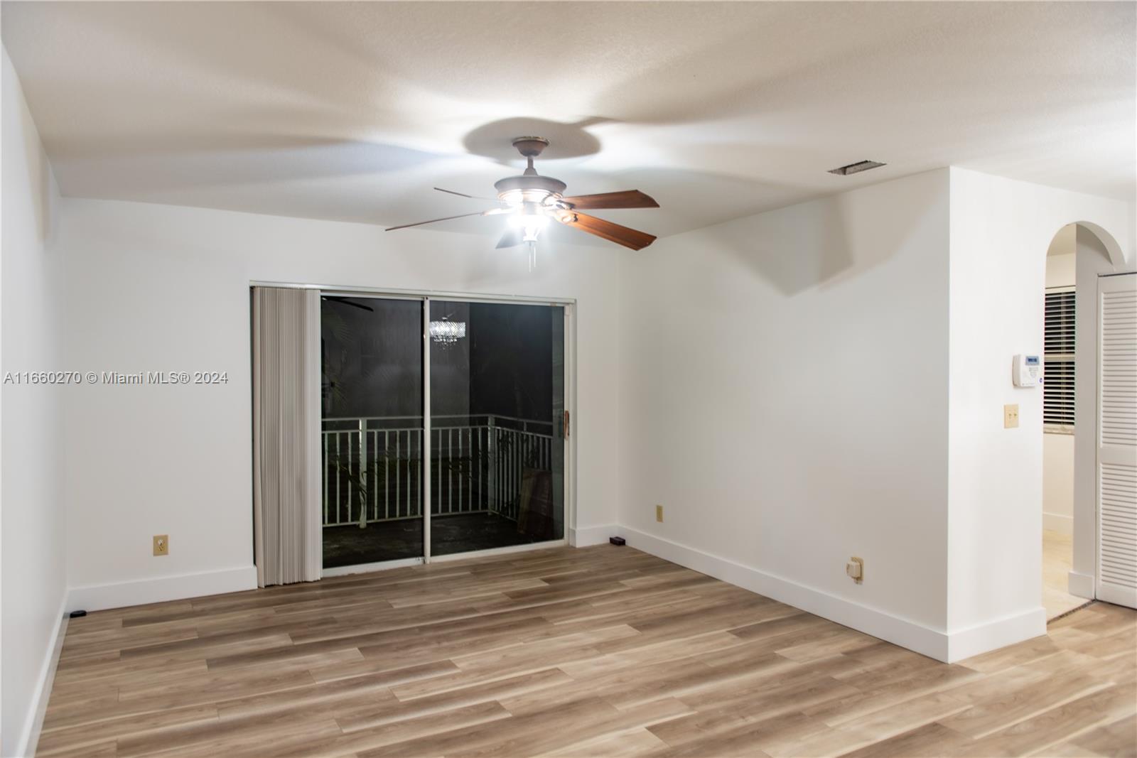 a view of a livingroom with a ceiling fan and wooden floor