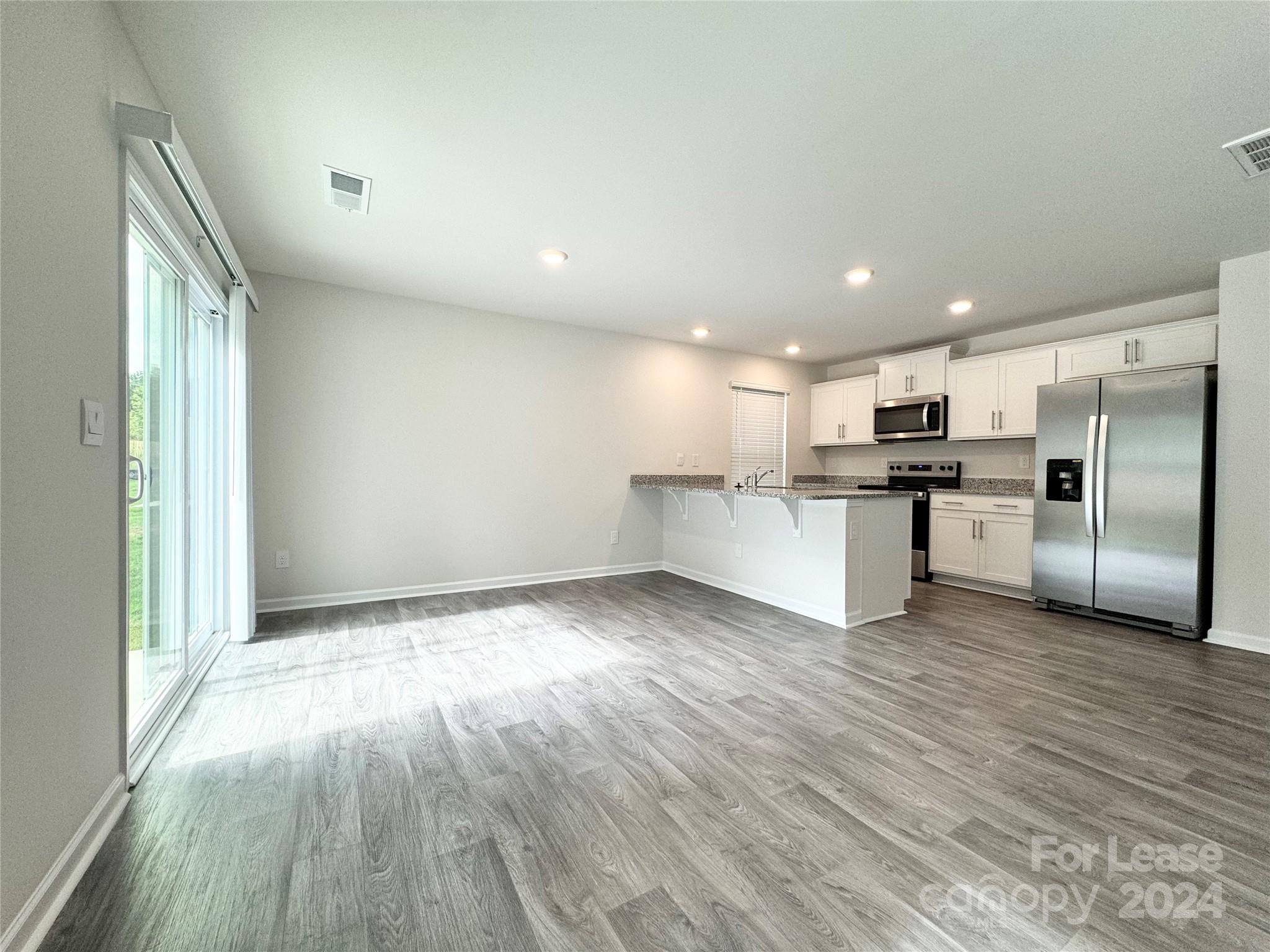 a view of kitchen with wooden floor