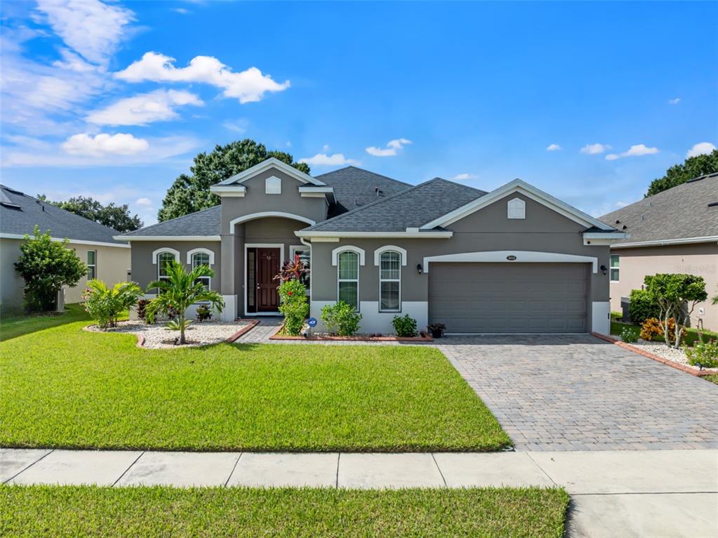 a front view of a house with a yard and porch