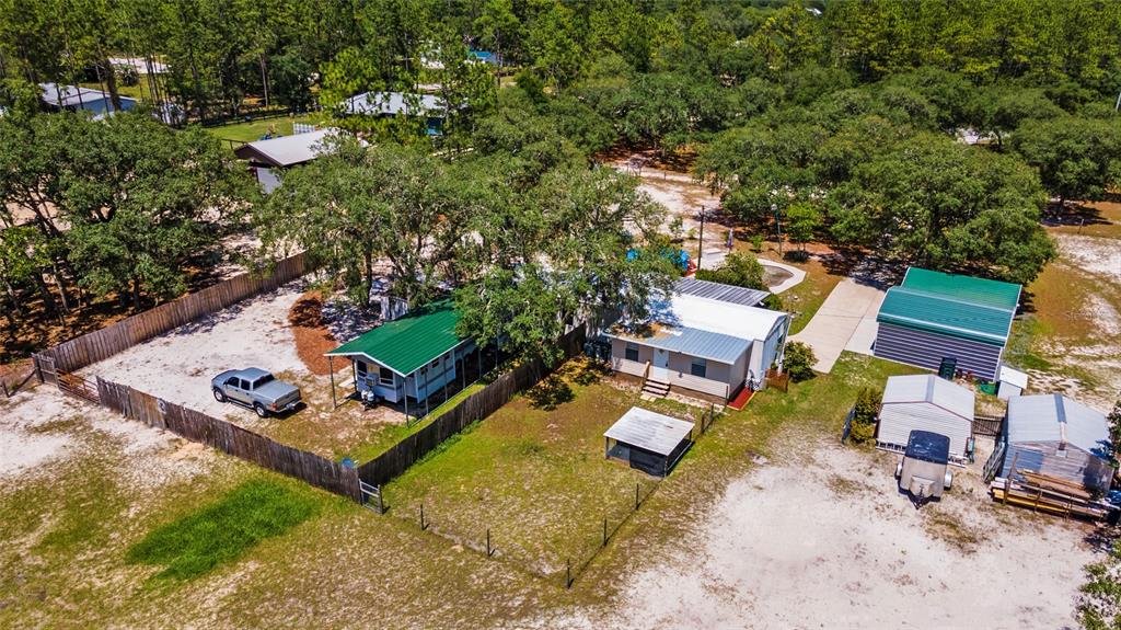 an aerial view of a house with a yard and lake view