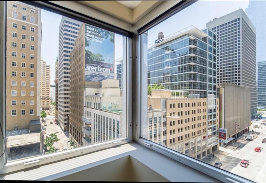 a view of a balcony and floor to ceiling windows