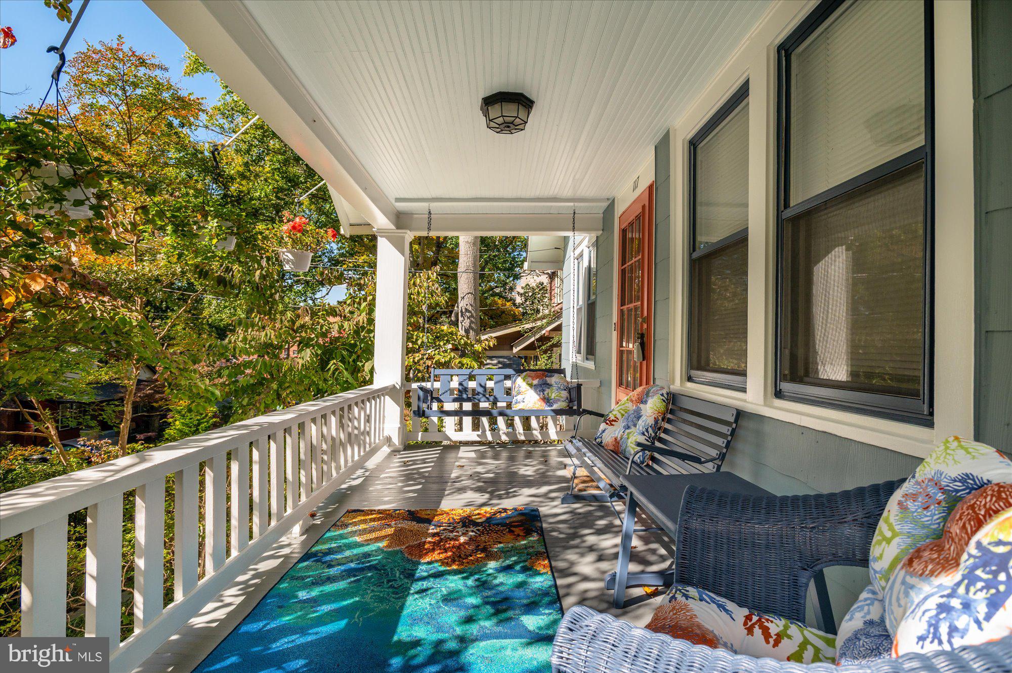 a balcony with furniture and wooden floor