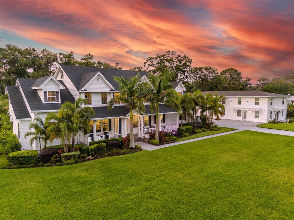 a aerial view of a house with a garden and lake view