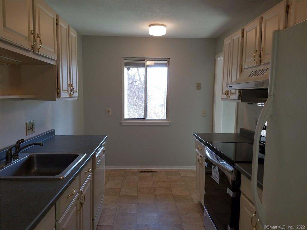 a kitchen that has a sink and a stove