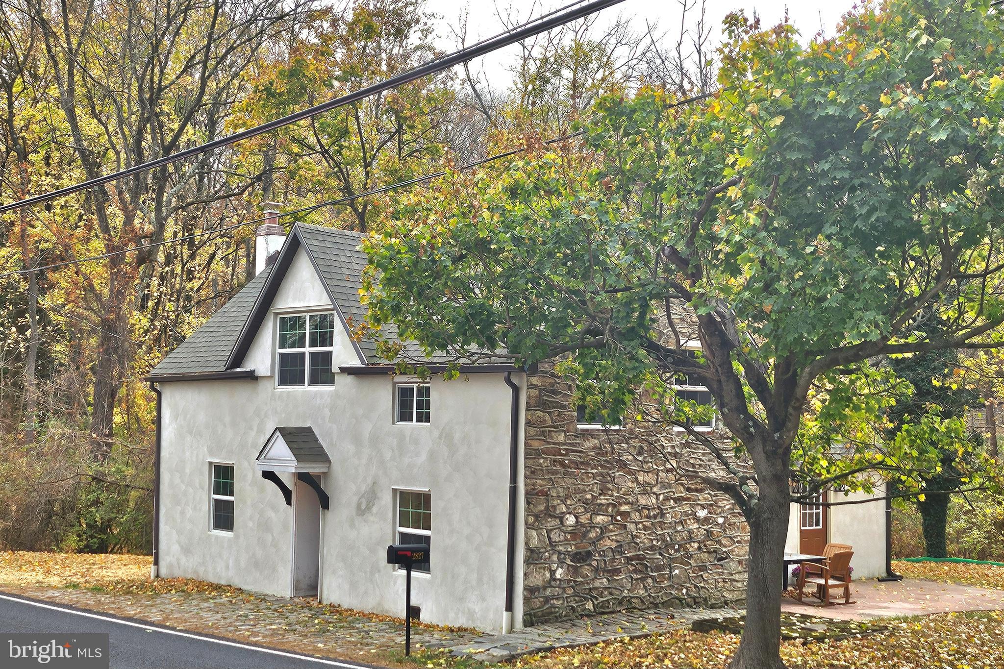 a front view of a house with trees