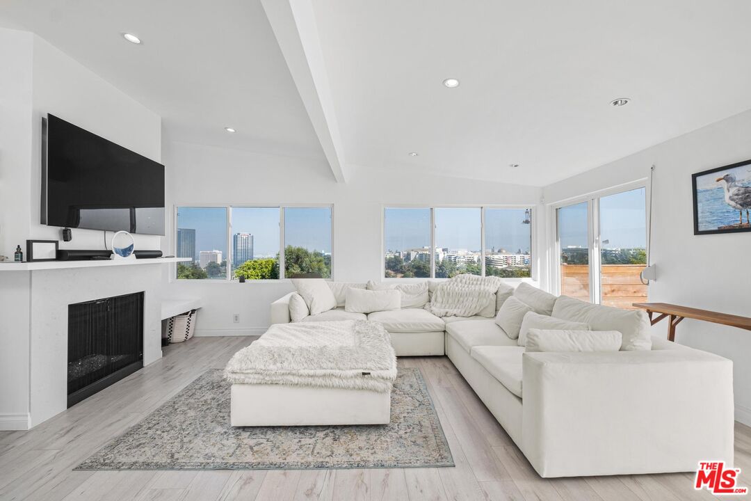 a living room with fireplace furniture and a flat screen tv