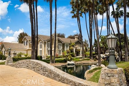 a view of a house with a swimming pool and sitting area