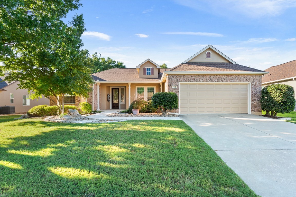 a front view of a house with a yard and garage