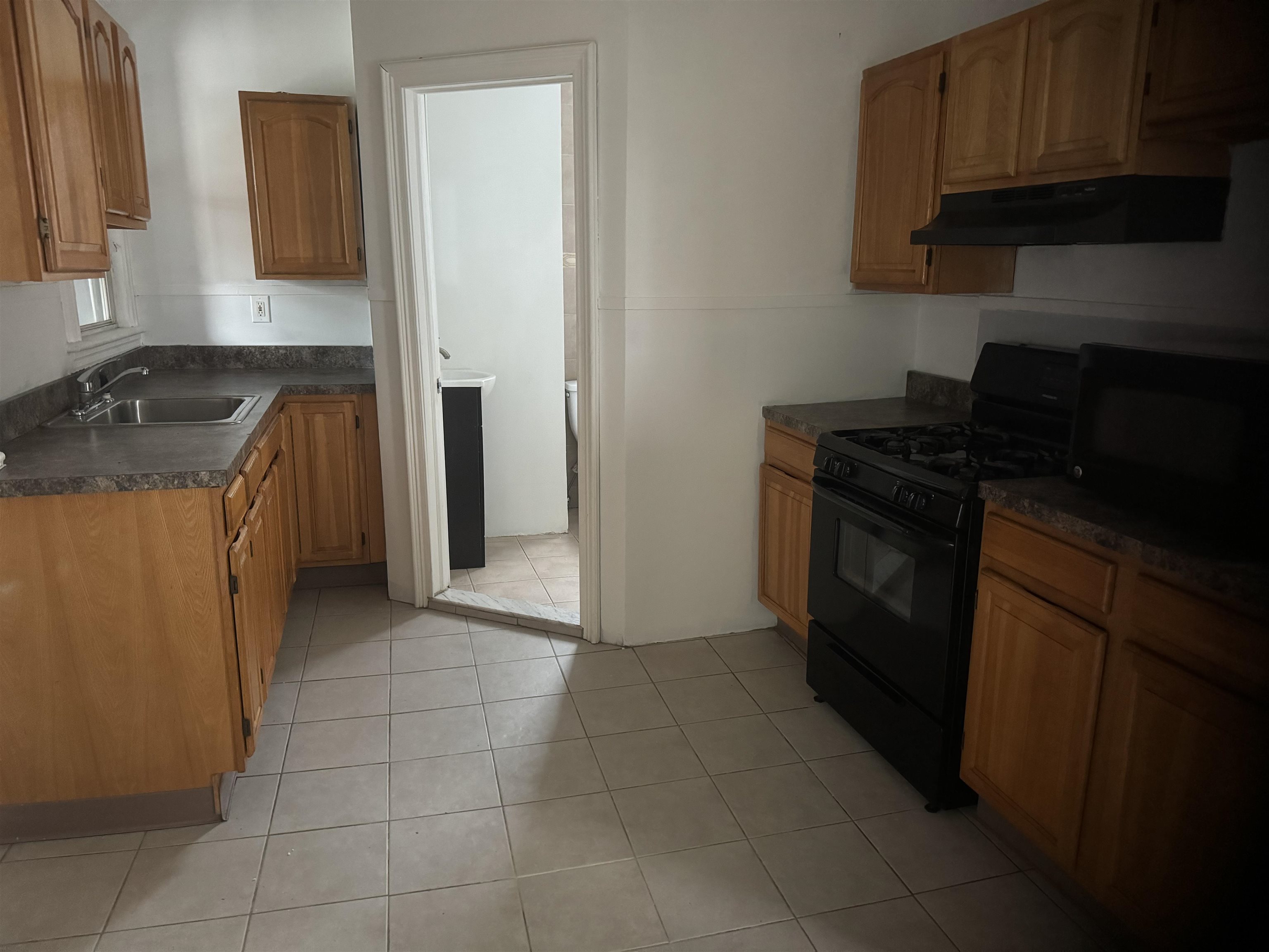 a kitchen with a stove top oven and cabinets