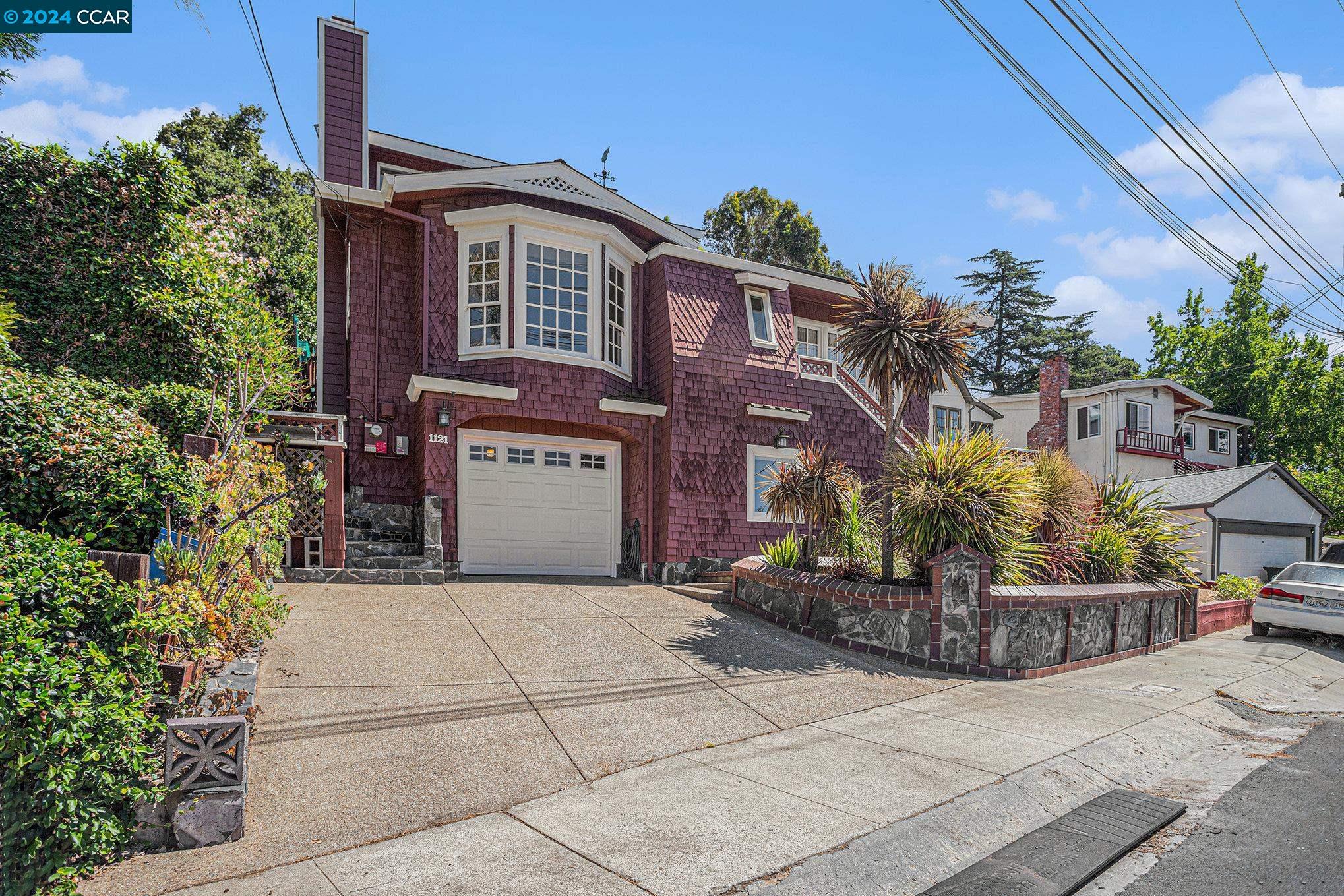 a front view of a house with a garden