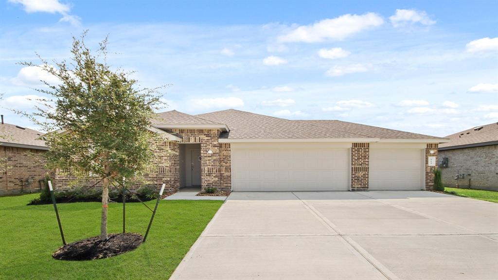 a front view of a house with a garden and yard