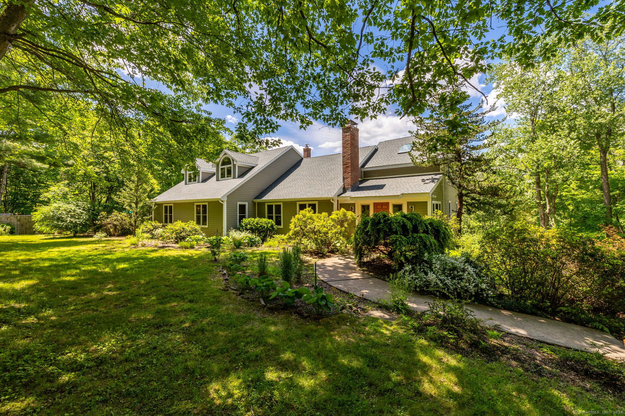 a front view of a house with garden