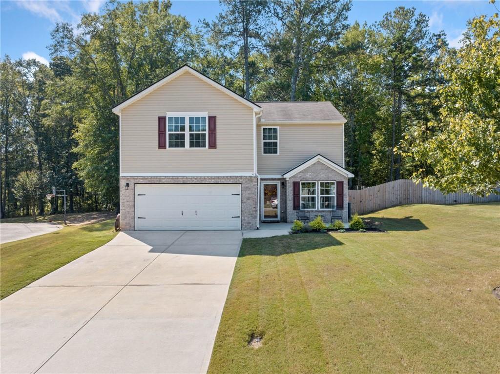 a front view of a house with a yard and garage