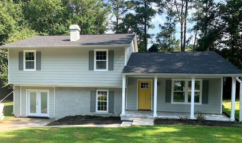 a front view of a house with yard and garage