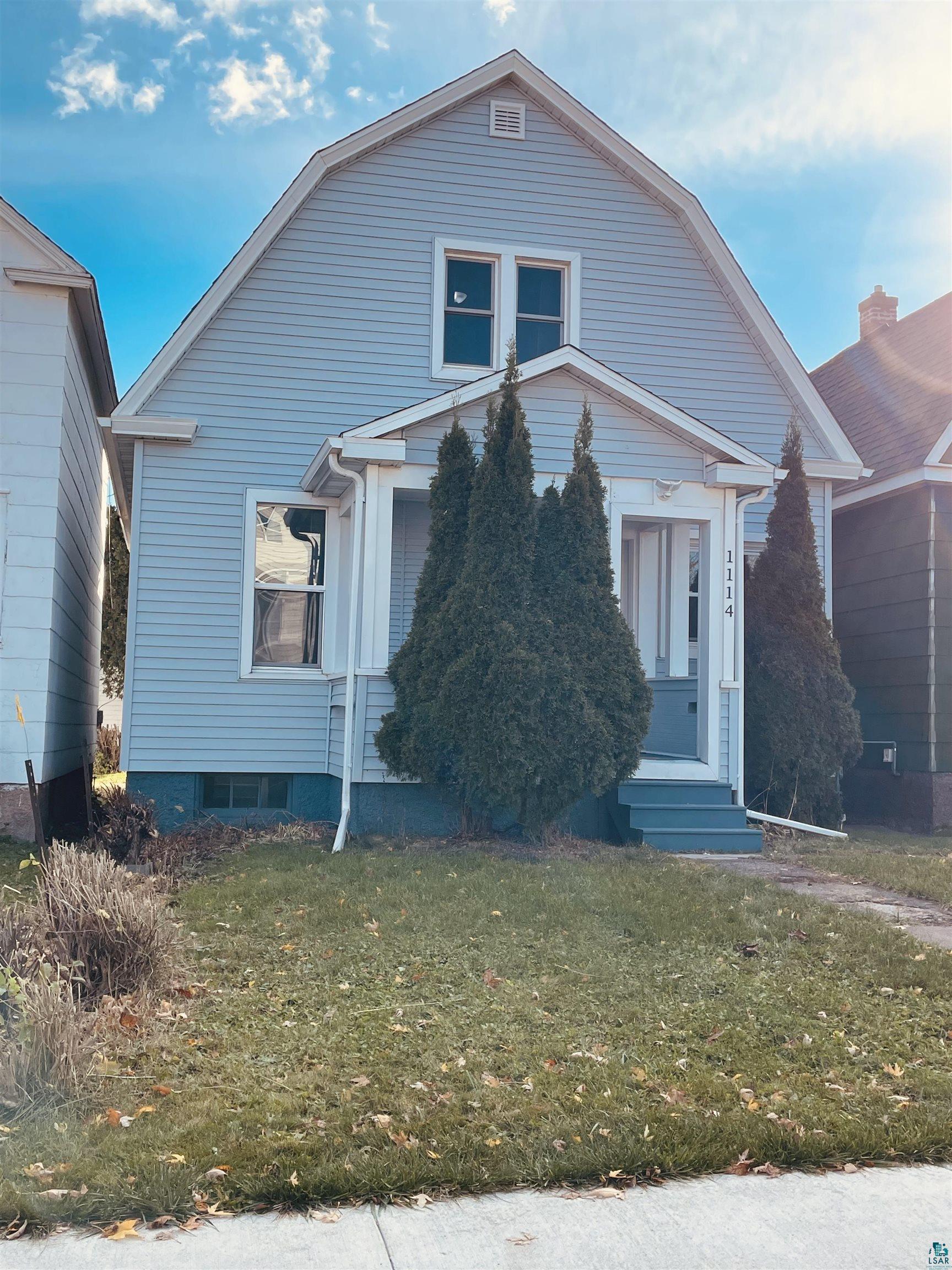 View of front of property with a front yard