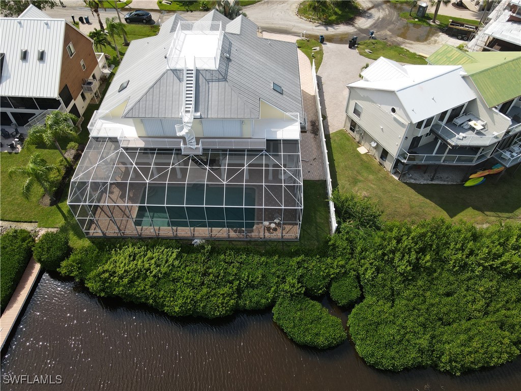 an aerial view of a house with a yard and potted plants