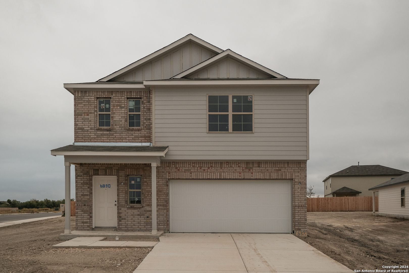 a front view of a house with garage