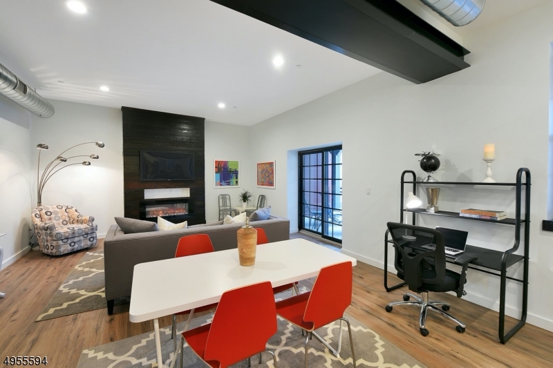 a living room with furniture a rug and a flat screen tv