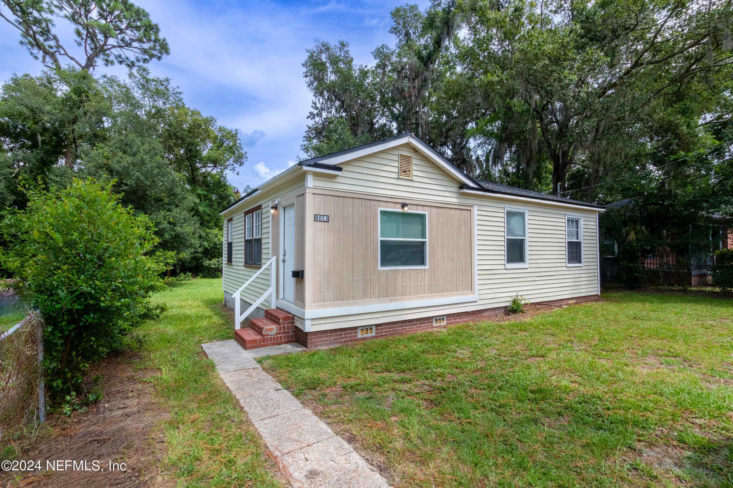 a front view of house with yard and green space