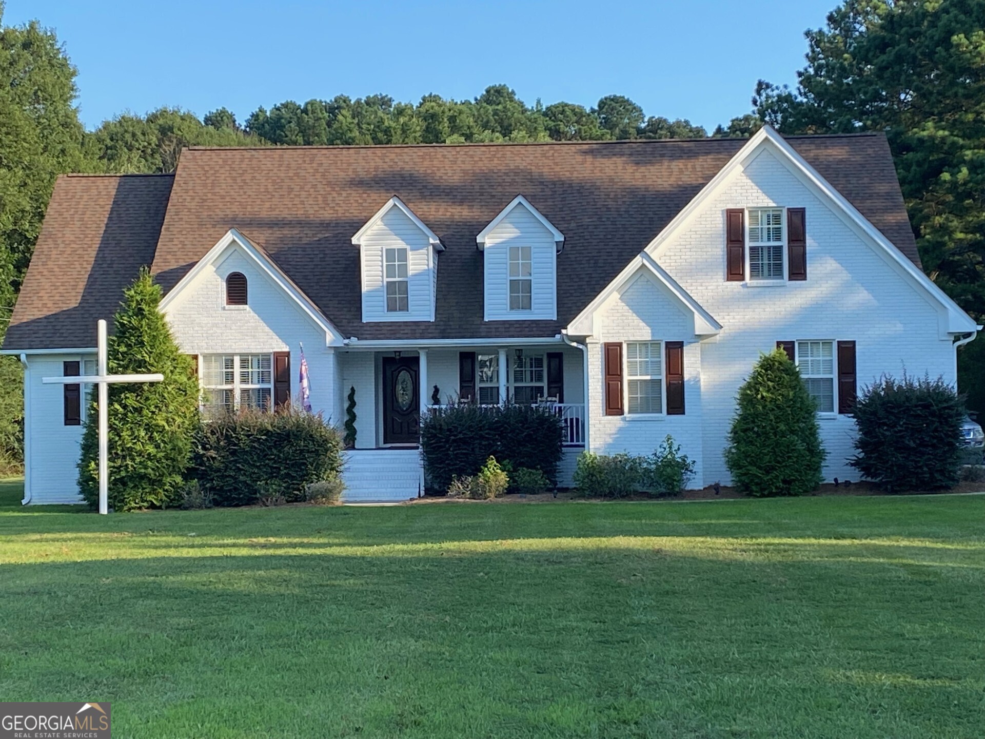 a front view of house with yard and green space