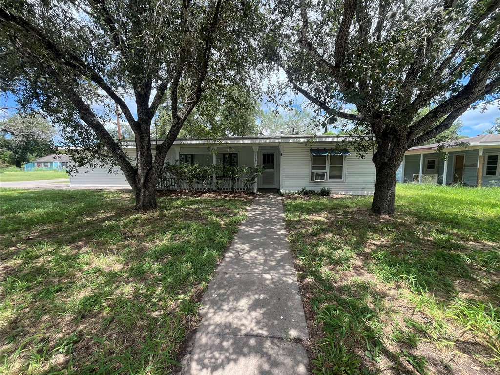 a front view of house with yard and green space