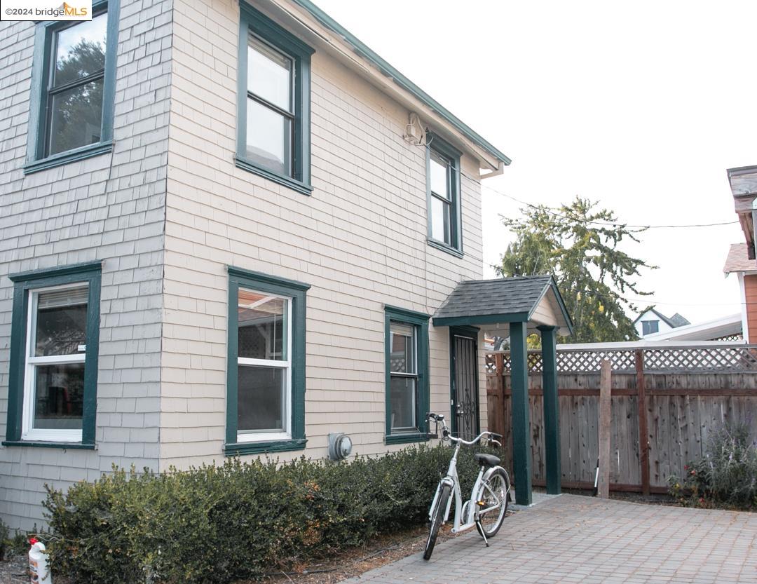 a view of a house with patio and wooden fence