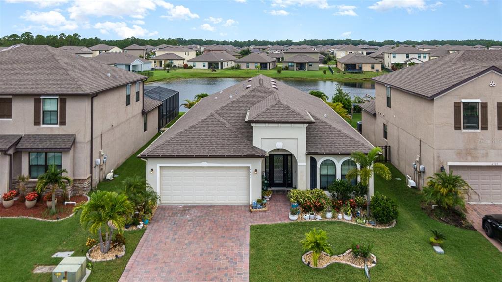 a aerial view of a house with a yard table and chairs