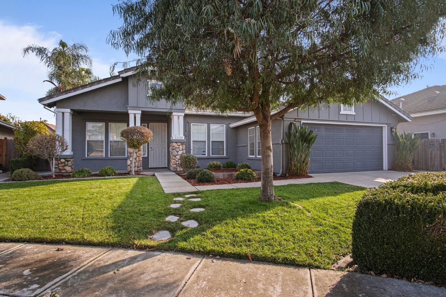 a front view of house with yard and outdoor seating