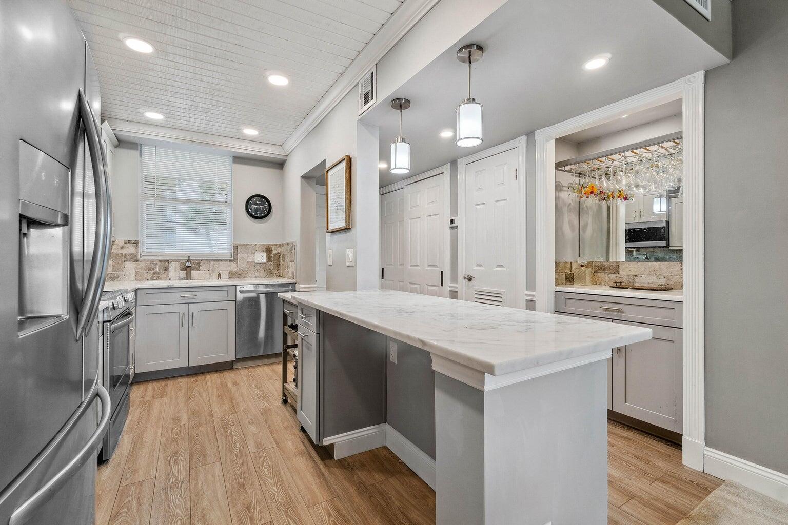 a kitchen with a sink stainless steel appliances and counter space